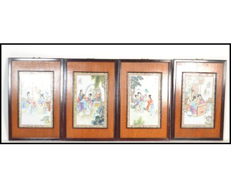 A set of four 20th century Chinese hardwood framed ceramic panels decorated with typical domestic scenes with calligraphy and