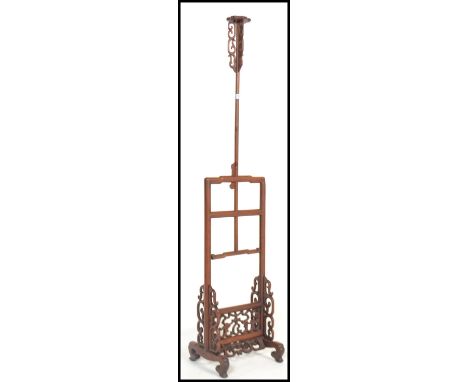 A vintage 20th century Chinese hardwood adjustable floor standing candlestick / lamp base having scrolled decoration with ban