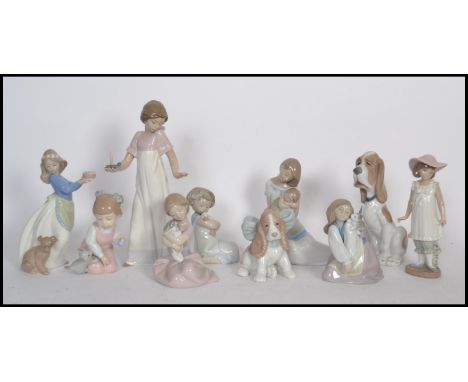 A collection of NAO ceramic figurines to include a mother and child figure, a girl holding a candle, a girl and a puppy, a to