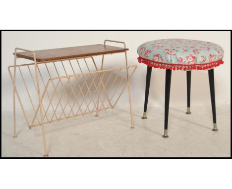 A retro / vintage mid 20th Century foot stool raised on four tapering legs with a circular stool to top having floral upholst