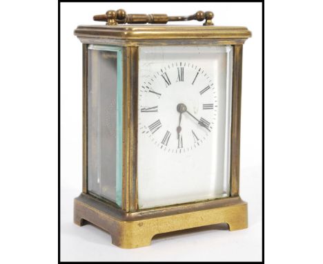 A circa 1900 French lacquered brass carriage clock, the enamel dial with Roman numerals chapter ring, glass panels all round 