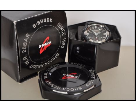 A casio G-Shock 20 Bar shock resist wrist watch having a large round face with pierced hands and three subsidiary dials inclu