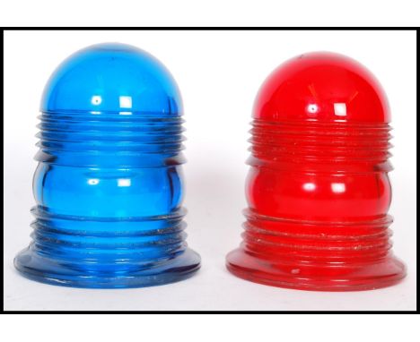 A pair of vintage coloured glass police siren light covers in blue and red. 12cm high 10cm diameter.&nbsp;