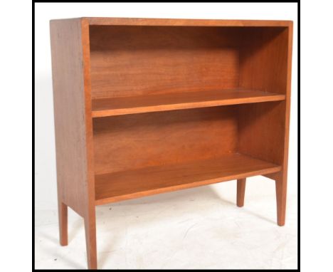 A retro 20th Century Danish influenced teak wood open bookcase, having a single adjustable shelf raised on angular supports.&