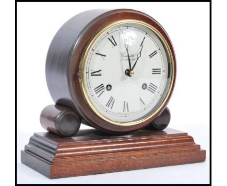 An early 20th century Edwardian Comitti Of London mahogany cased mantle bracket clock. Raised on stepped plinth base with bar