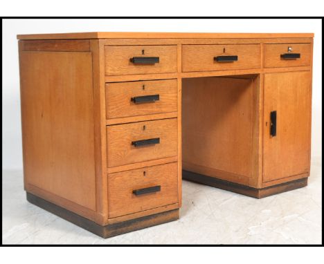 A good 1930's Art Deco golden oak twin pedestal desk - Air Ministry manner. The green writing surface over twin pedestals wit