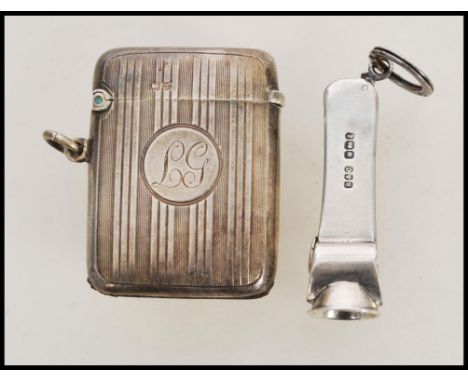 A silver hallmarked cheroot cutter along with a silver hallmarked vesta case. The vesta match case having striker to base wit