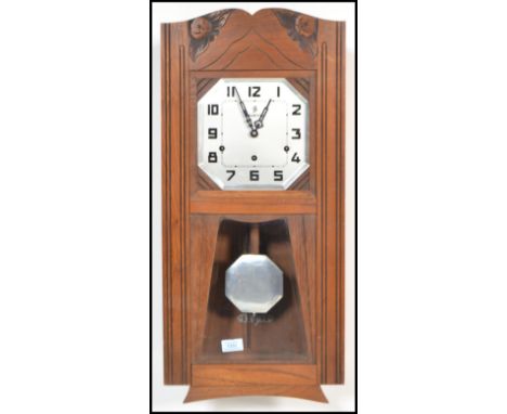 A vintage 20th century Art Deco French walnut cased wall clock, with silvered dial by Vedette having glazed panel front revea