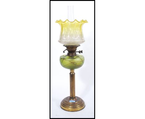 A Victorian 19th century Loetz glass and brass oil lamp. The neo-classical brass body with reeded column supporting a green i
