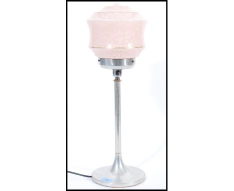 A vintage retro 20th century Art Deco lamp raised on a circular chrome base with tall column and gilt banded pink glass shade