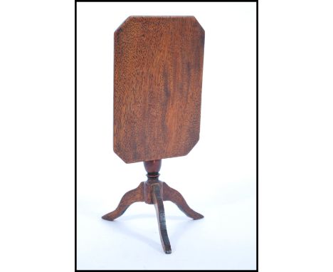 A 19th Century miniature large scale dolls house mahogany tilt top table raised on a central turned column with three splayed