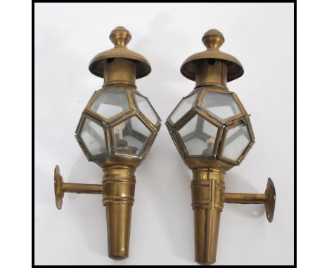 A pair of 19th Century Victorian brass carriage lamps having glazed pentagonal windows with finial tops and brackets.&nbsp;