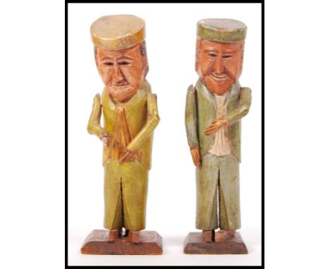 A pair of antique early 20th century ' Folk Art ' style carved wooden figures - possibly Russian or German in origin. Each de