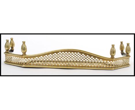 A 19th century Victorian brass Art Nouveau work kerb bedroom fire fender / fire guard of small proportions having twist finia