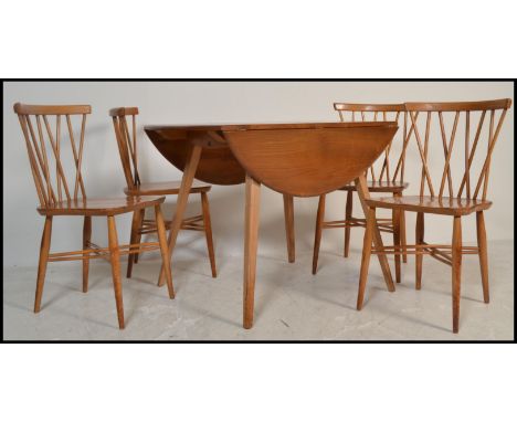 A vintage retro Ercol drop leaf dining table along with a set of four vintage mid 20th Century Ercol Windsor beech and elm cr