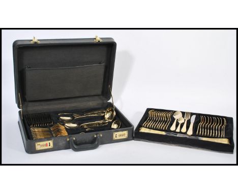 A vintage Solingen of W Germany 23-24 carat gold-plated canteen of cutlery for twelve settings including knives, forks, spoon