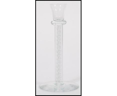 A 19th Century Victorian glass candlestick holder having an air twist / helix column on a round foot and tulip sconce. Measur