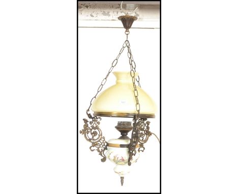 An early 20th Century electric Continental brass and ceramic rise and fall ceiling chandelier with and Central decorated cera
