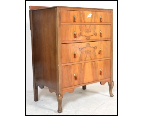 A 1930's Art Deco walnut chest of drawers being raised on cabriole legs with upright bank of drawers having good deco handles