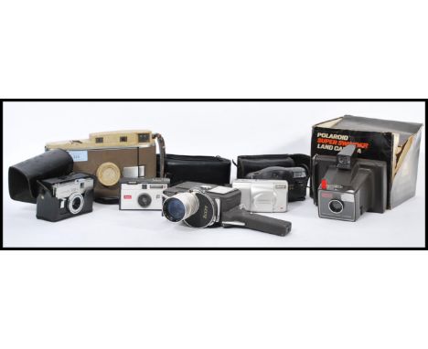 A collection of vintage cameras and accessories to include an early Polaroid Land camera, a Kodak EK160, another Polaroid and