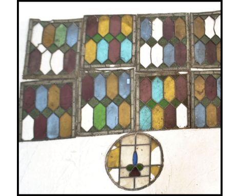 A collection of 19th Century Art Nouveau leaded stained glass window panels, nine in total, eight square and a single round w