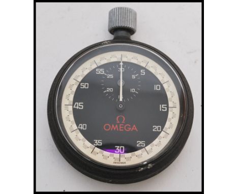 A vintage 20th century Omega stopwatch timer clock of pocket watch shape complete in original box. Black dial with Red Omega 