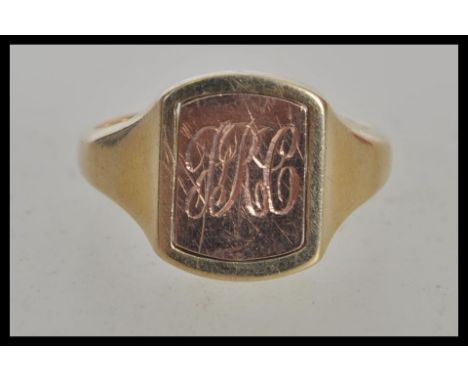 A hallmarked 9ct gold signet ring having a rectangular head with a turnable centre one side bearing masonic markings the othe