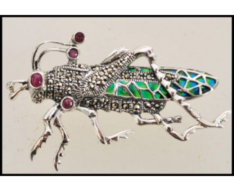 A stamped 925 silver plique a jour brooch in the form of a grass hopper set with rubies to the eyes and antenna. Total weight