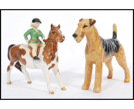 A 20th Century Beswick ceramic Skewbald Pony with a female rider, in green jacket, stamped to base Beswick, together with a c