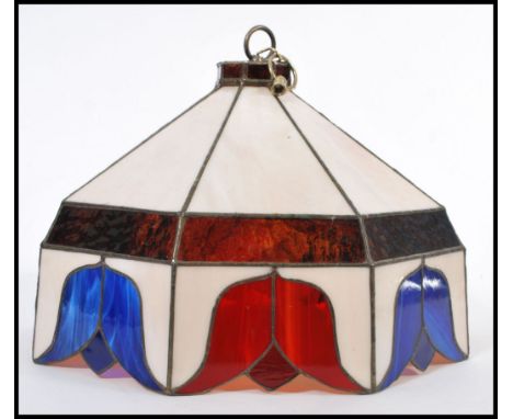 A vintage Tiffany style lamp shade having coloured leaded stained glass panels. Tulip pattern with red and blue flowers and w