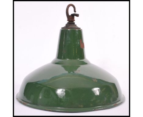 A vintage retro industrial factory green enamelled metal ceiling pendant lamp shade, retaining original ceramic fitting with 