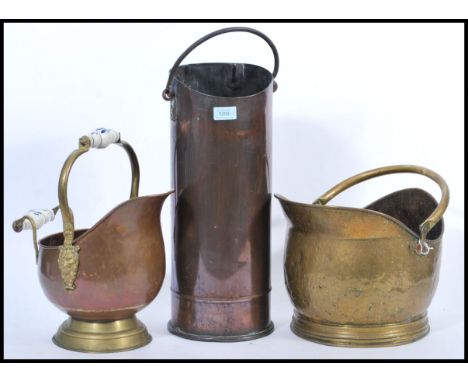 A group of antique fireside items to include two 19th century brass and copper coal scuttle with ceramic handles and lion mas