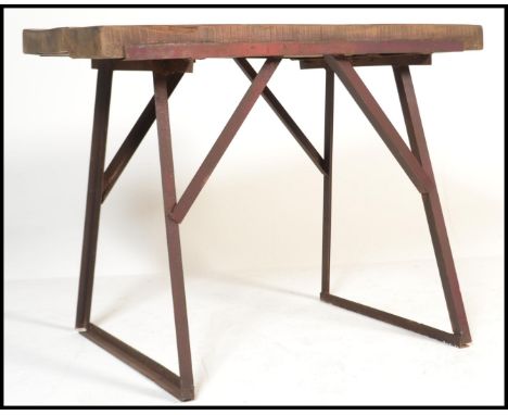 A 20th century Industrial butchers block style work bench. Raised on a cast steel metal a-frame base having planked wooden to