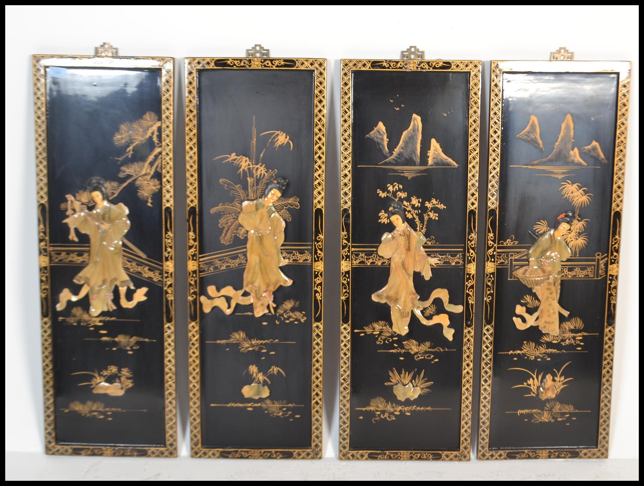 A set of vintage 20th Century four Chinese lacquer wall plaques of rectangular form, having gilt