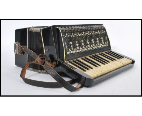 A 20th Century German Fremielio piano accordion having 18 celluloid keys reading Fremielio in jewelled lettering, and 24 whit