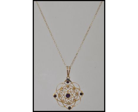 A 15ct gold Art Nouveau necklace and pendant chain being adorned with amethyst and seed pearls being then set to a 9ct gold c