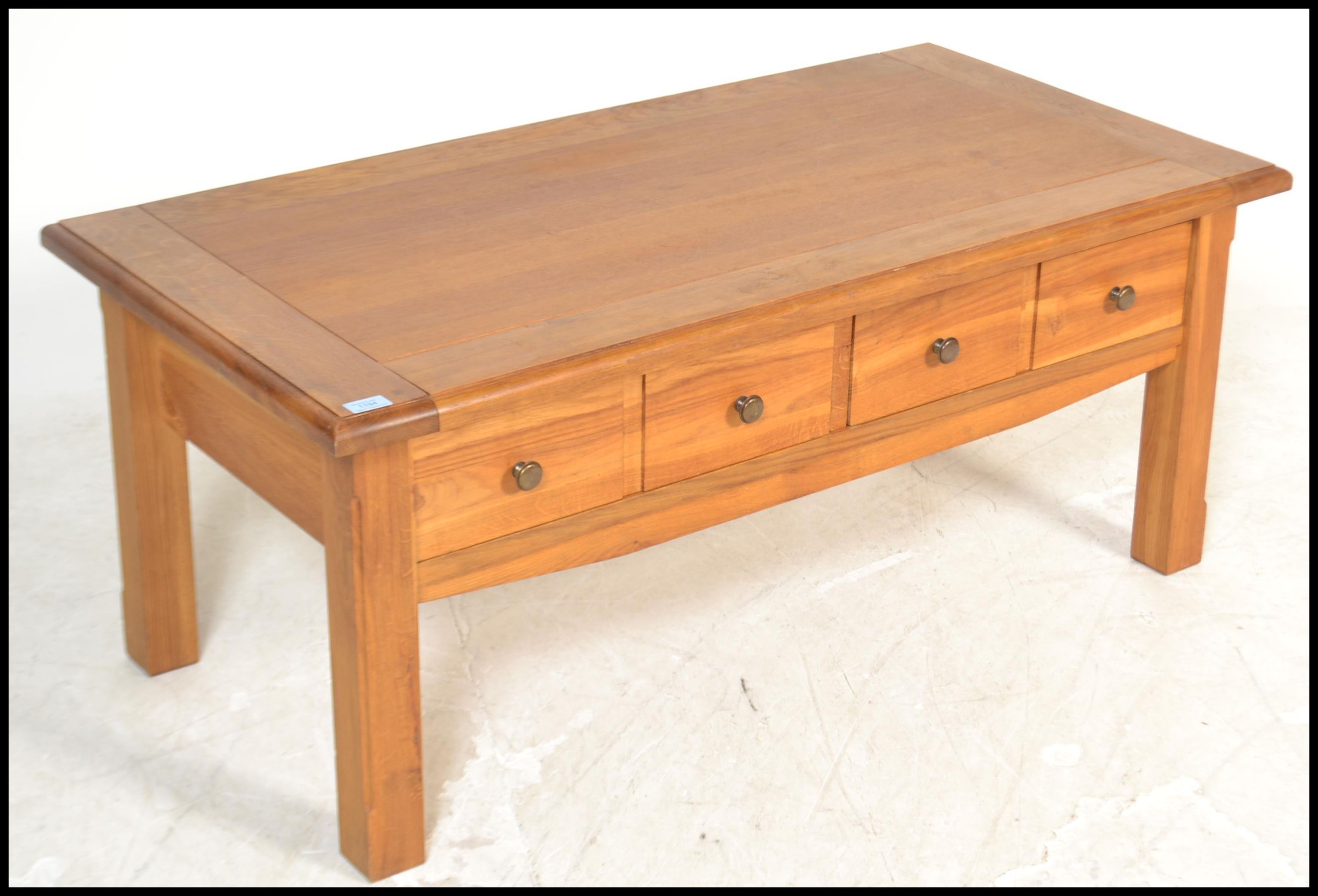 A contemporary chunky oak ' furniture land ' style coffee table of