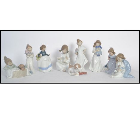 A collection of nao / NAO figurines to include a puppy with a Christmas stocking, a girl with a tea tray, a girls with a fan,