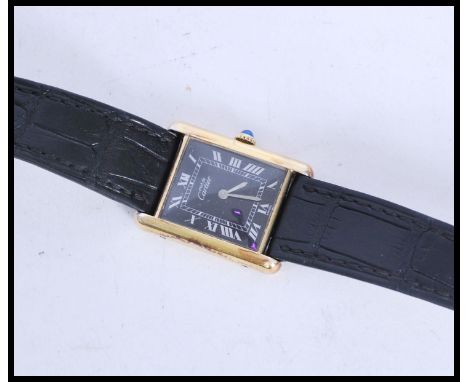 A vintage Cartier Must De watch having a 20m gold plated sterling silver 925 case and set to a vintage black leather strap. T