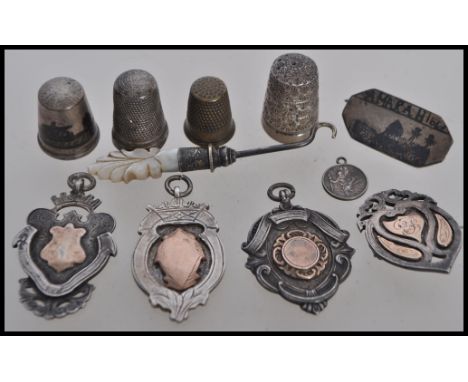 A selection of silver and metal items to include four hallmarked silver sporting medals/ badges three being unengraved, a sil