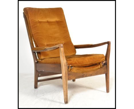 A vintage mid 20th Century open armed fireside beech armchair / elbow chair by Cintique, Raised on tapered angular supports w