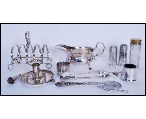 A collection of silver plated items to include a Martin Hall &amp; Co silver plated creamer jug on pad feet, a chamber stick 