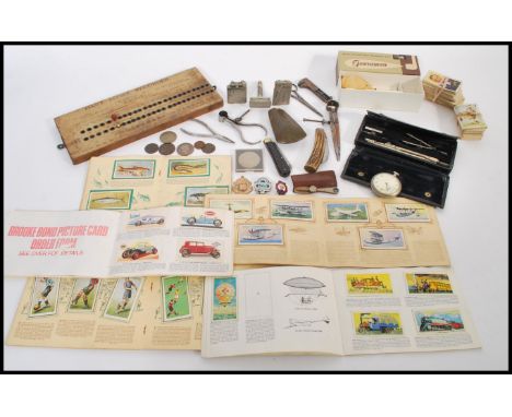 A dealers lot to include a Neolithic stone axehead, a Post &amp; Spook Anker pocket watch, Polo lighter, pen knives, coins, t