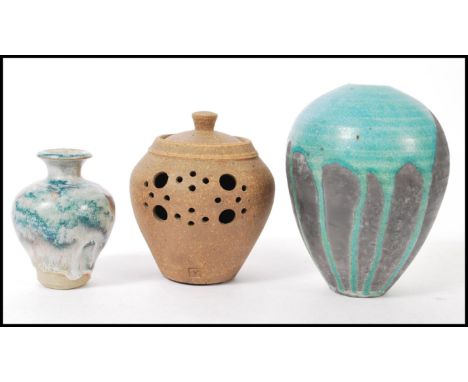 A group of vintage studio art pottery to include blue drip glaze bulbous vase, brown earthenware lidded pot, and a baluster v