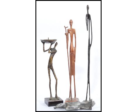 A group of three vintage 20th century bronze African figures / statues to include a candlestick heaturing a man holding the s