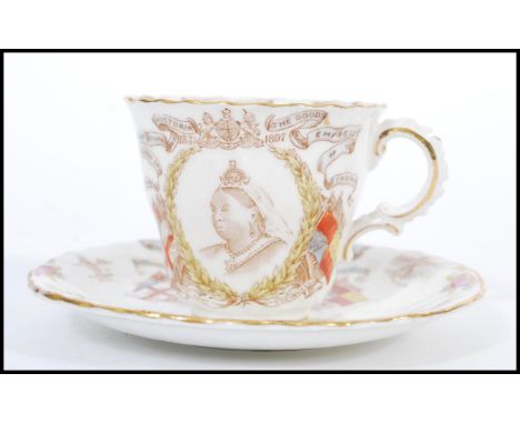 A 19th Century Victorian cupboard display commemorative cup and saucer for the diamond jubilee 1837-1897. The cup featuring a