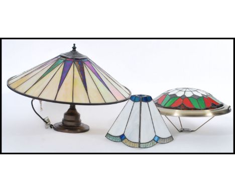 A group of vintage Tiffany style stained glass lamps and shades to include on lamp with leaded glass shade and two smaller sh
