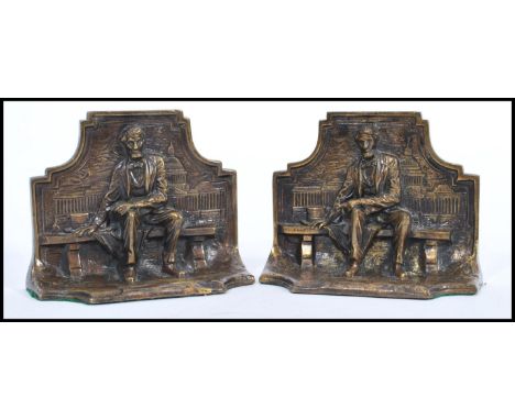 A pair of early 20th century bronze bookends in the form of Abraham Lincoln seated on bench. Made in England and dating to 19
