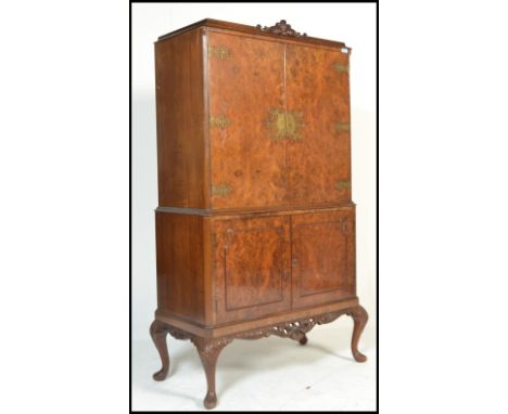 A vintage 20th century 1950's Art Deco style burr walnut tall cocktail cabinet raised on cabriole legs with cupboard base and