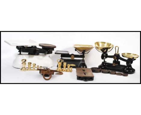 A collection of vintage 20th century shop / industrial weighing scales having cast metal bases. Most complete with weights. A